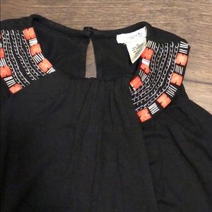 Cache Tops - Black top with orange and silver embellishments Cache Tops - Black top with orange and silver embellishments